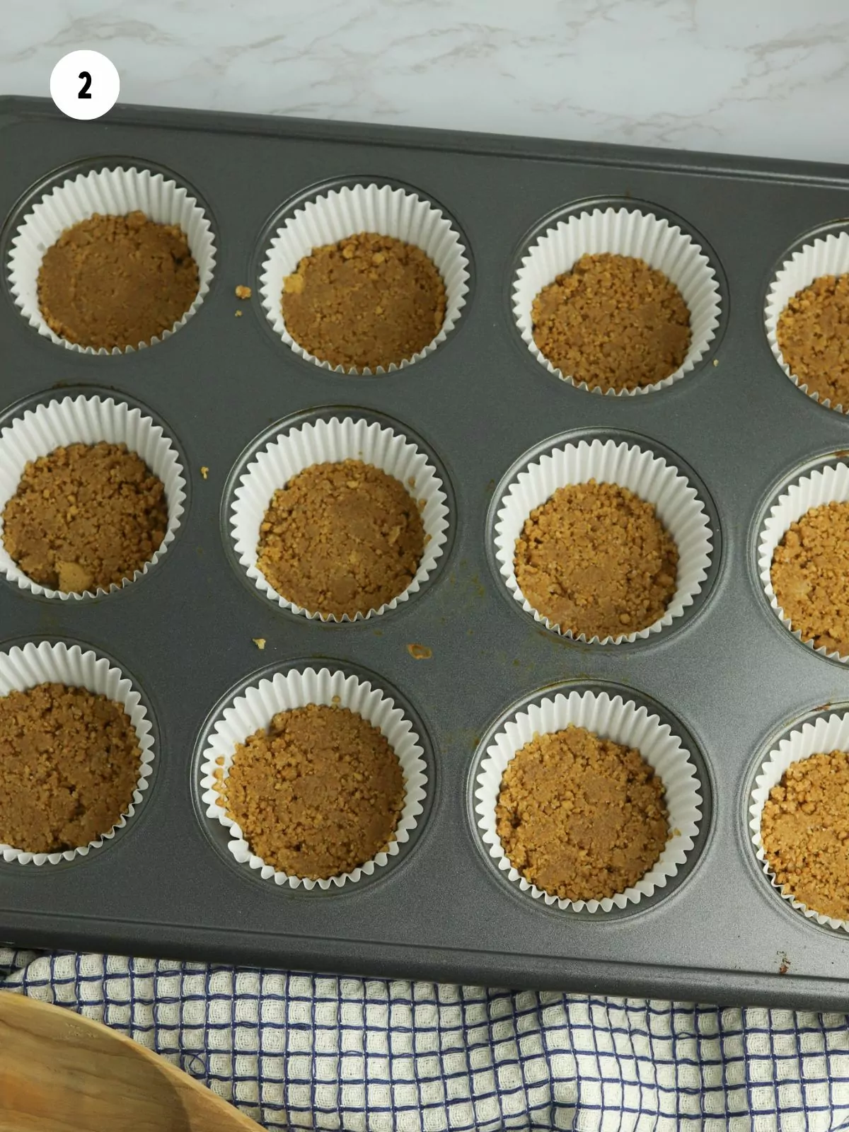 crust pressed into liners in a muffin pan