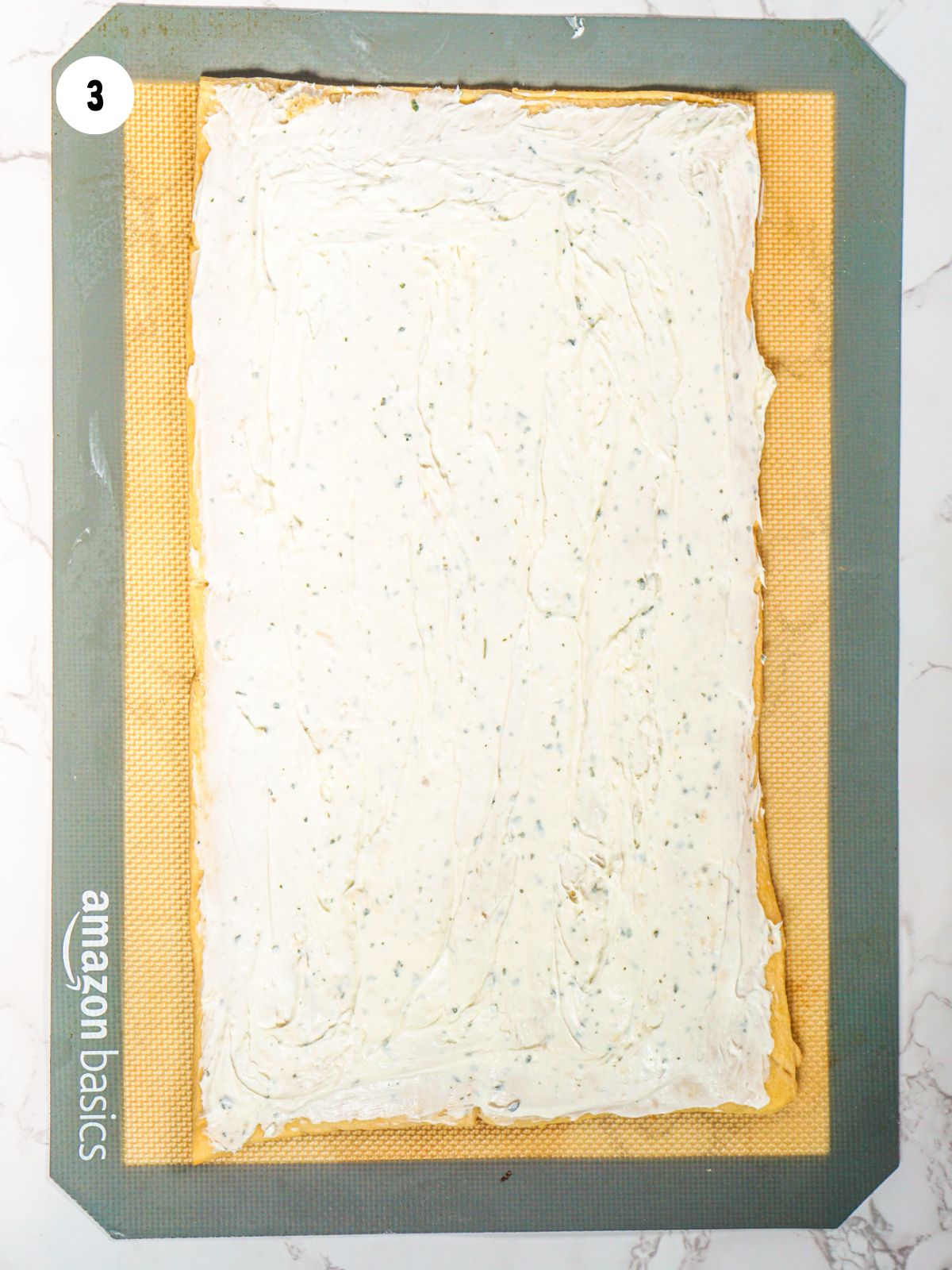 seasoned cream cheese spread on baked dough