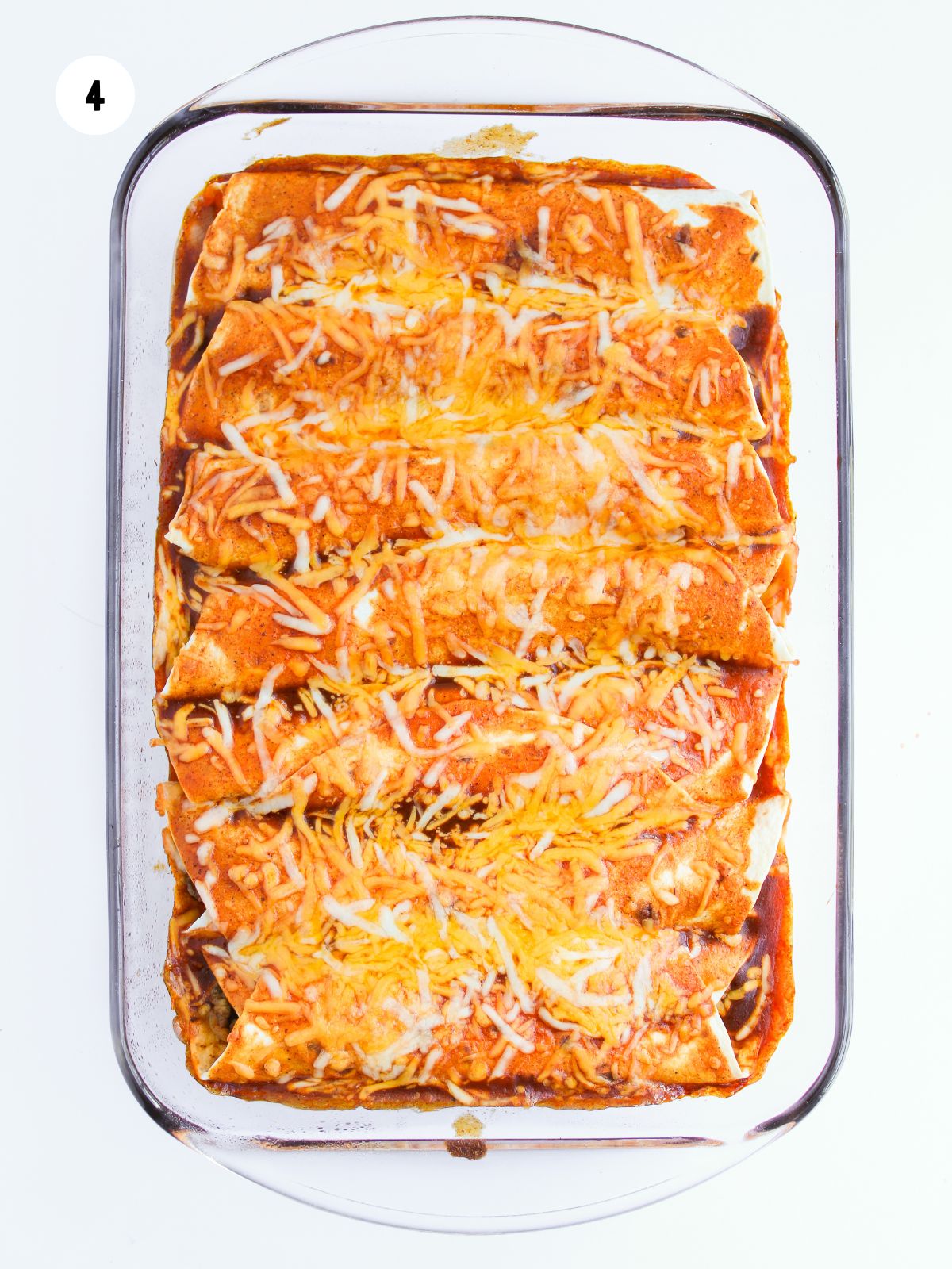 baked cheesy enchiladas in a glass dish