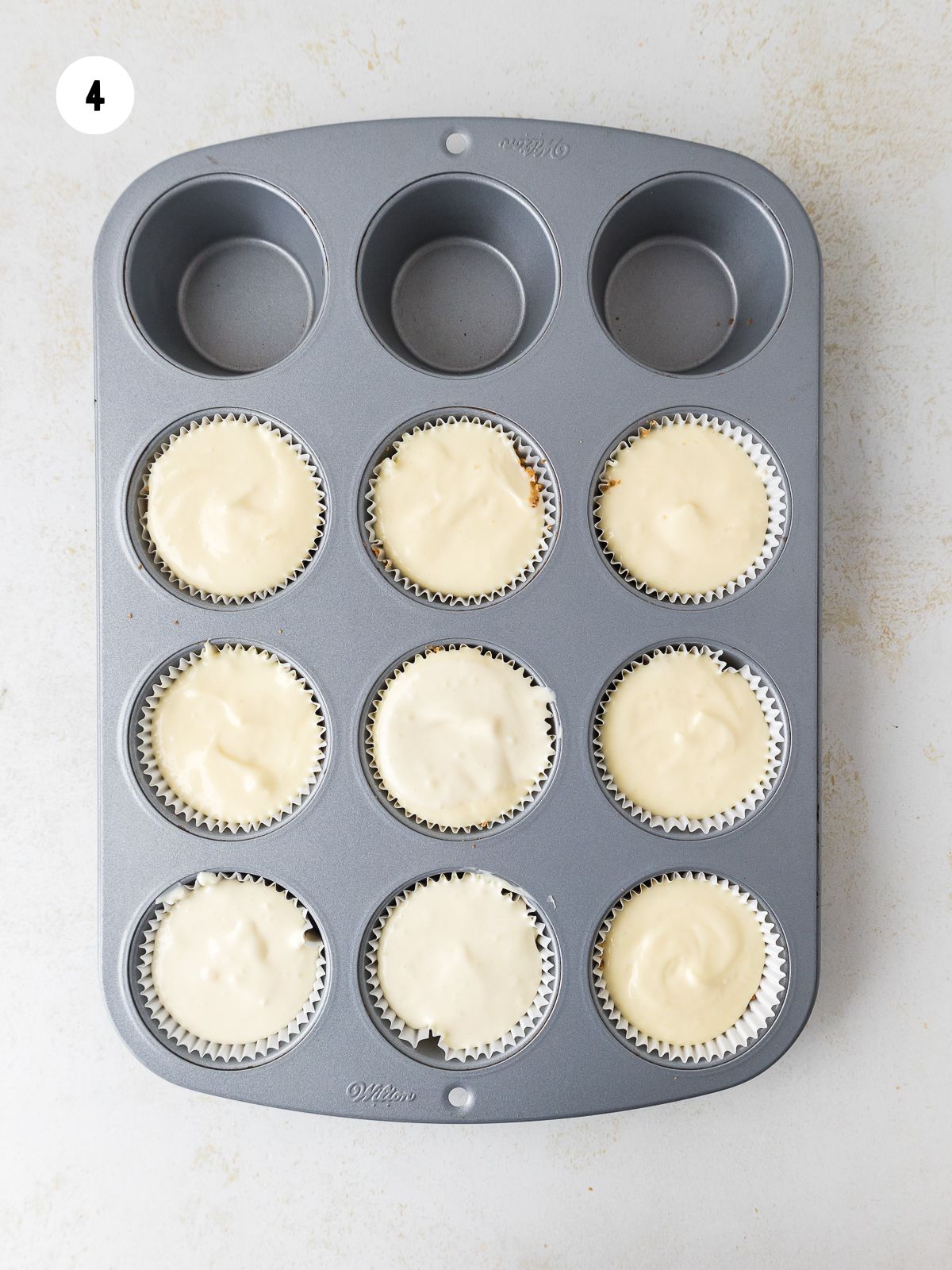 cheesecake filling added to the crusts in the muffin pan