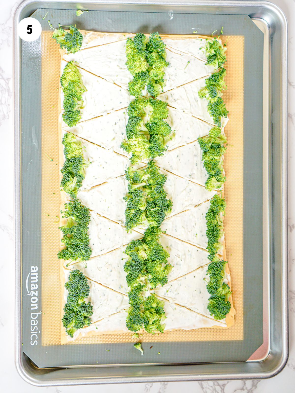 broccoli lined up along the wide end of the triangles