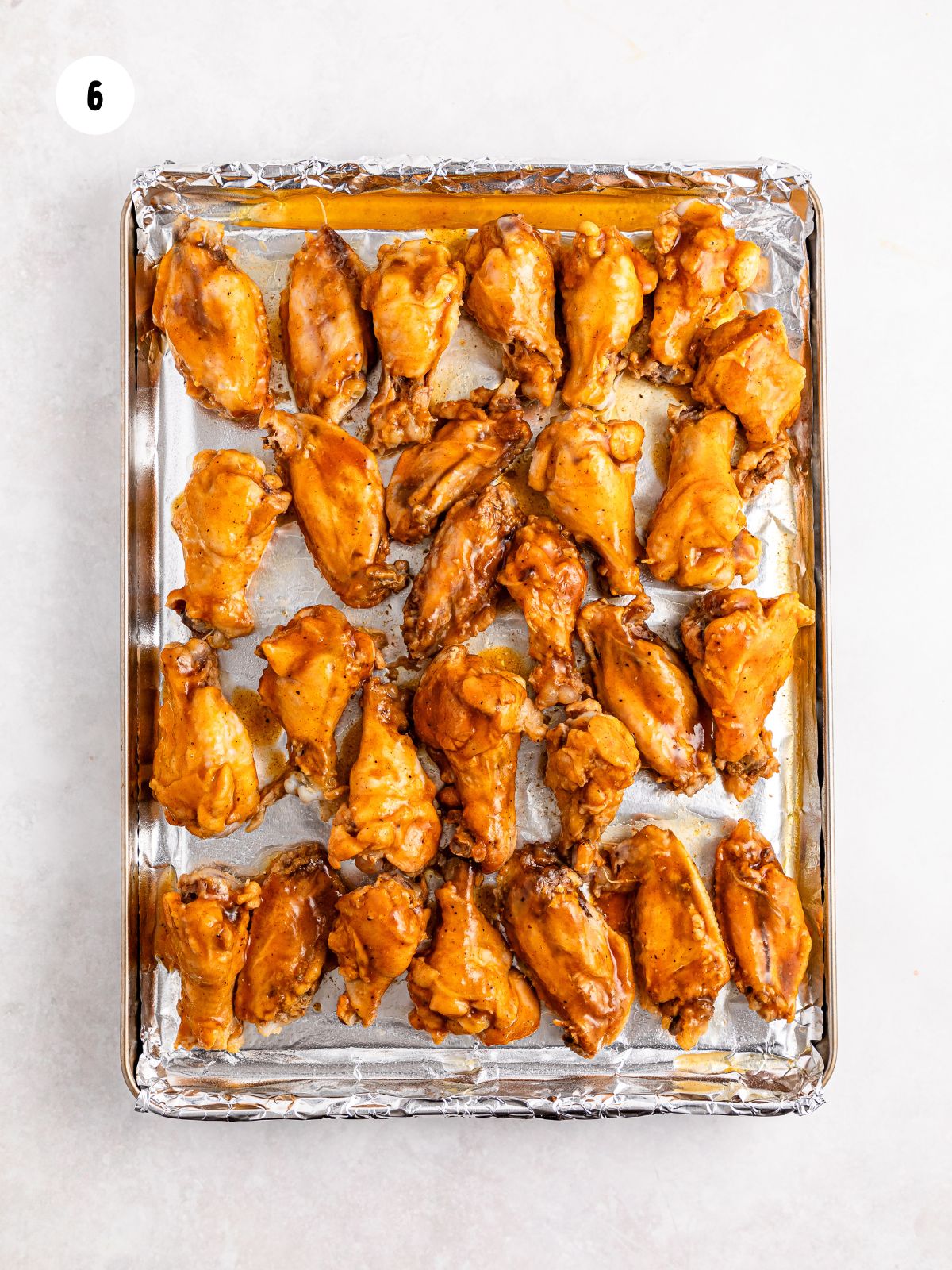 wings placed on a sheet pan lined with foil