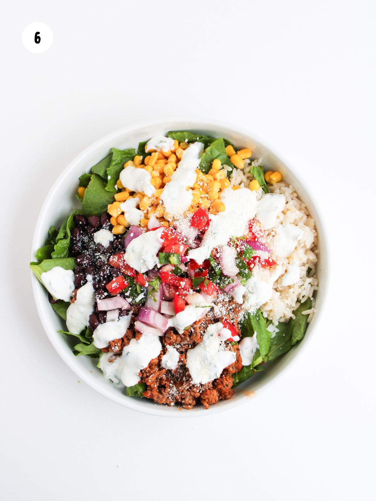 taco salad topped with cilantro lime sour cream and cotija cheese
