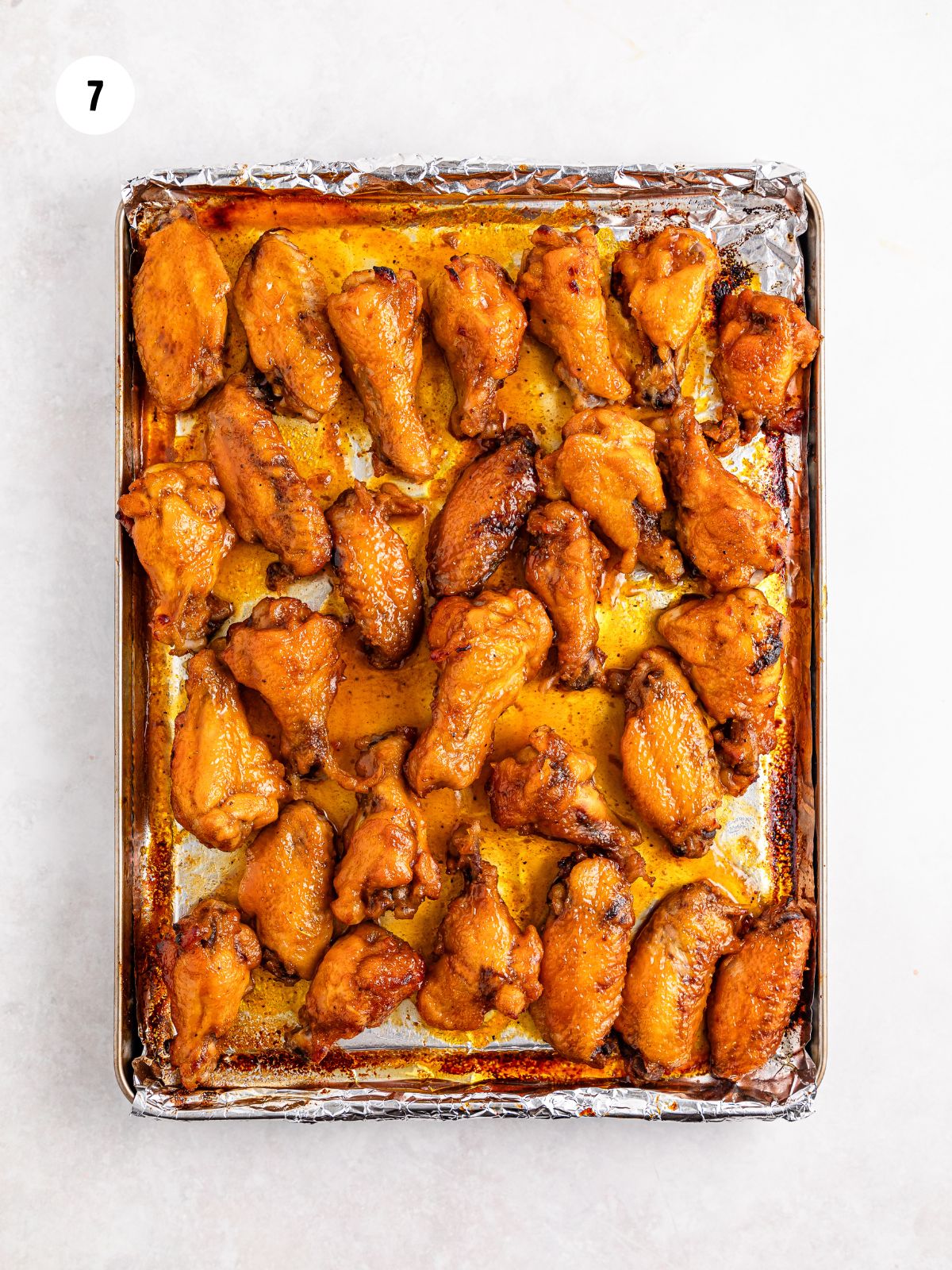 broiled wings on a foil lined sheet pan