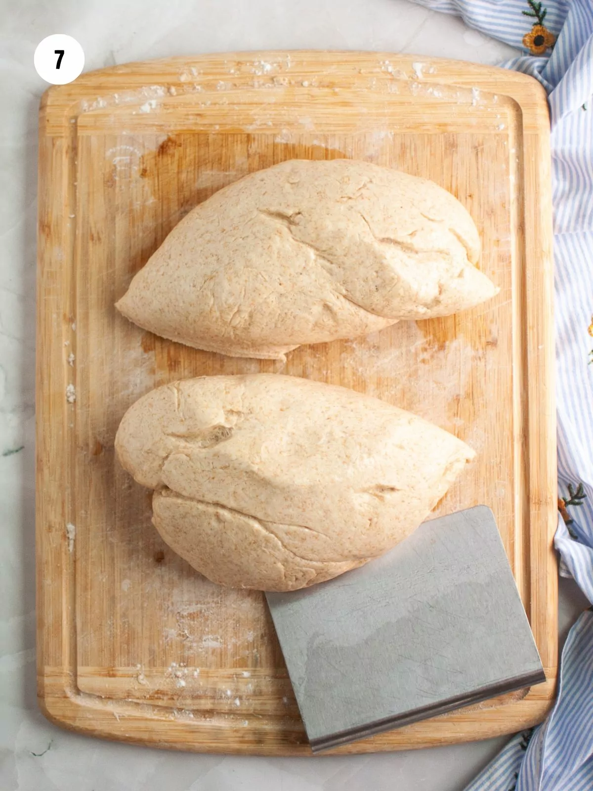 dough divided in half with a bench scraper