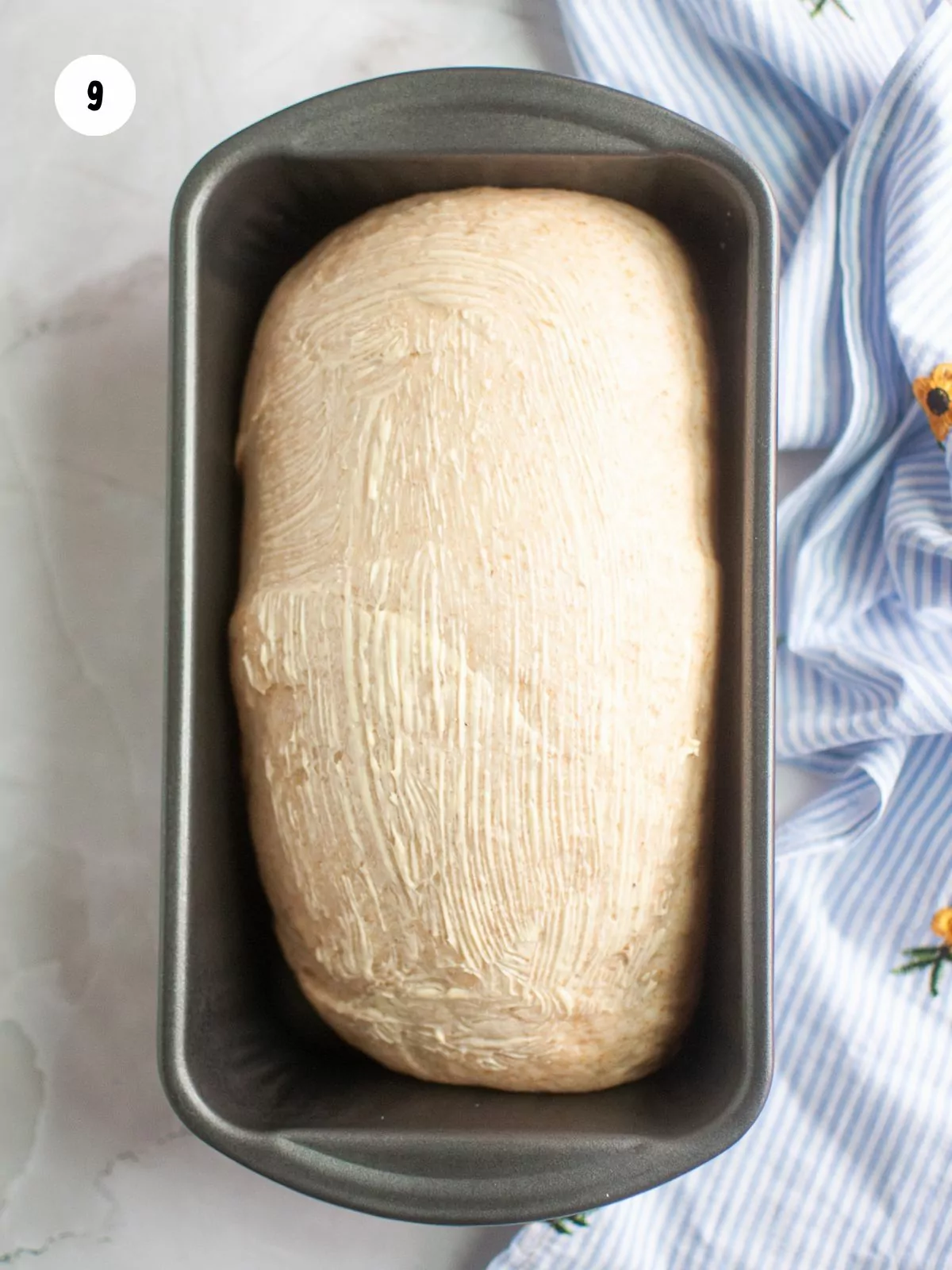 butter brushed on top of the risen dough
