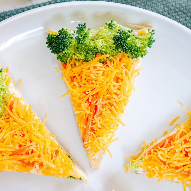 slice of veggie pizza decorated like a carrot