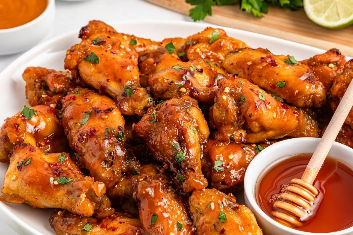 Crispy honey garlic chicken wings coated in sticky glaze.