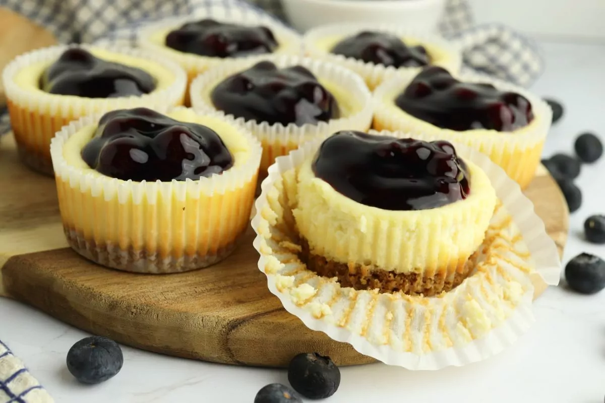 Mini Blueberry Cheesecakes with the front one's wrapper pulled back