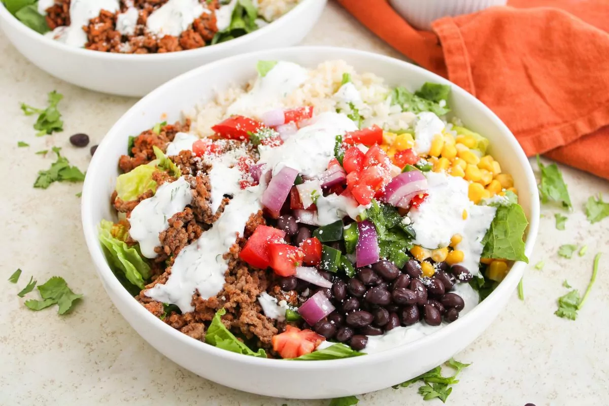 Fresh taco salad bowls filled with seasoned meat, lettuce, and crispy tortilla shells.