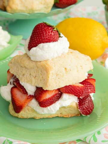 strawberry shortcake dessert on green plate.
