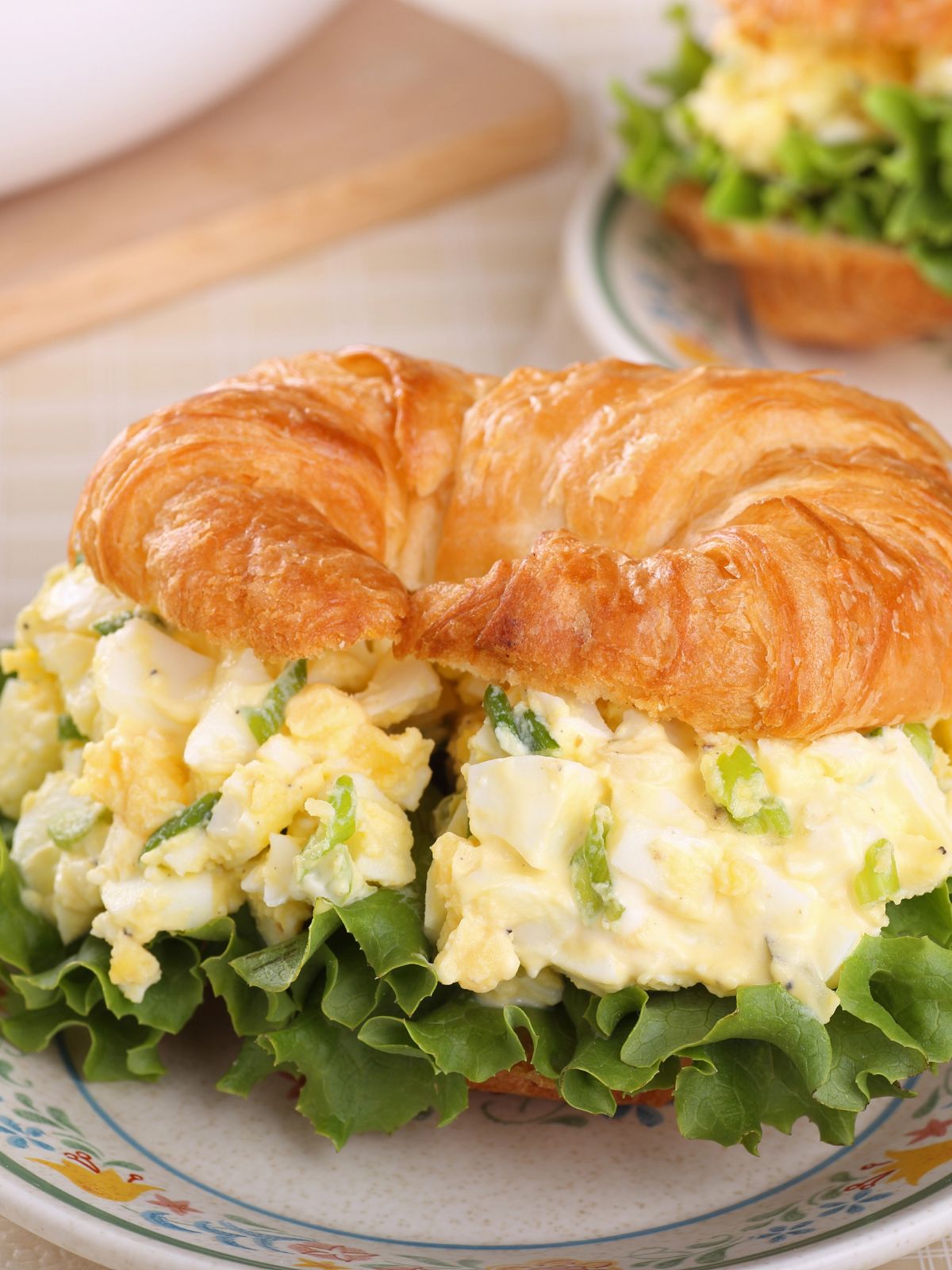 egg salad with lettuce on croissant.