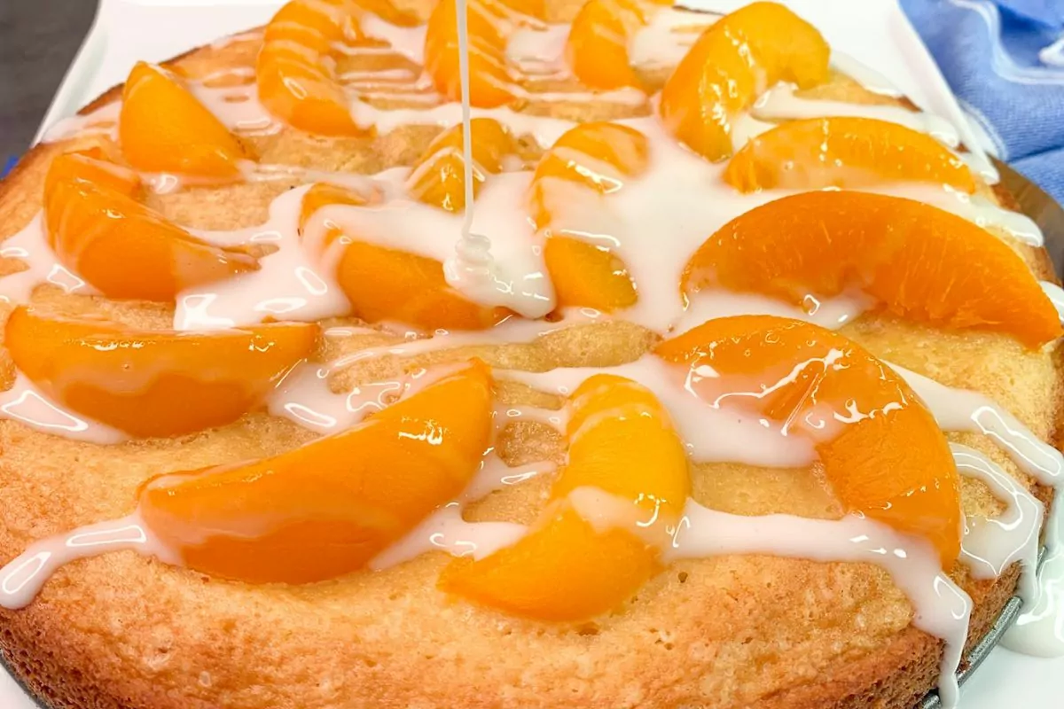 closeup of peach cake with glaze MSN.