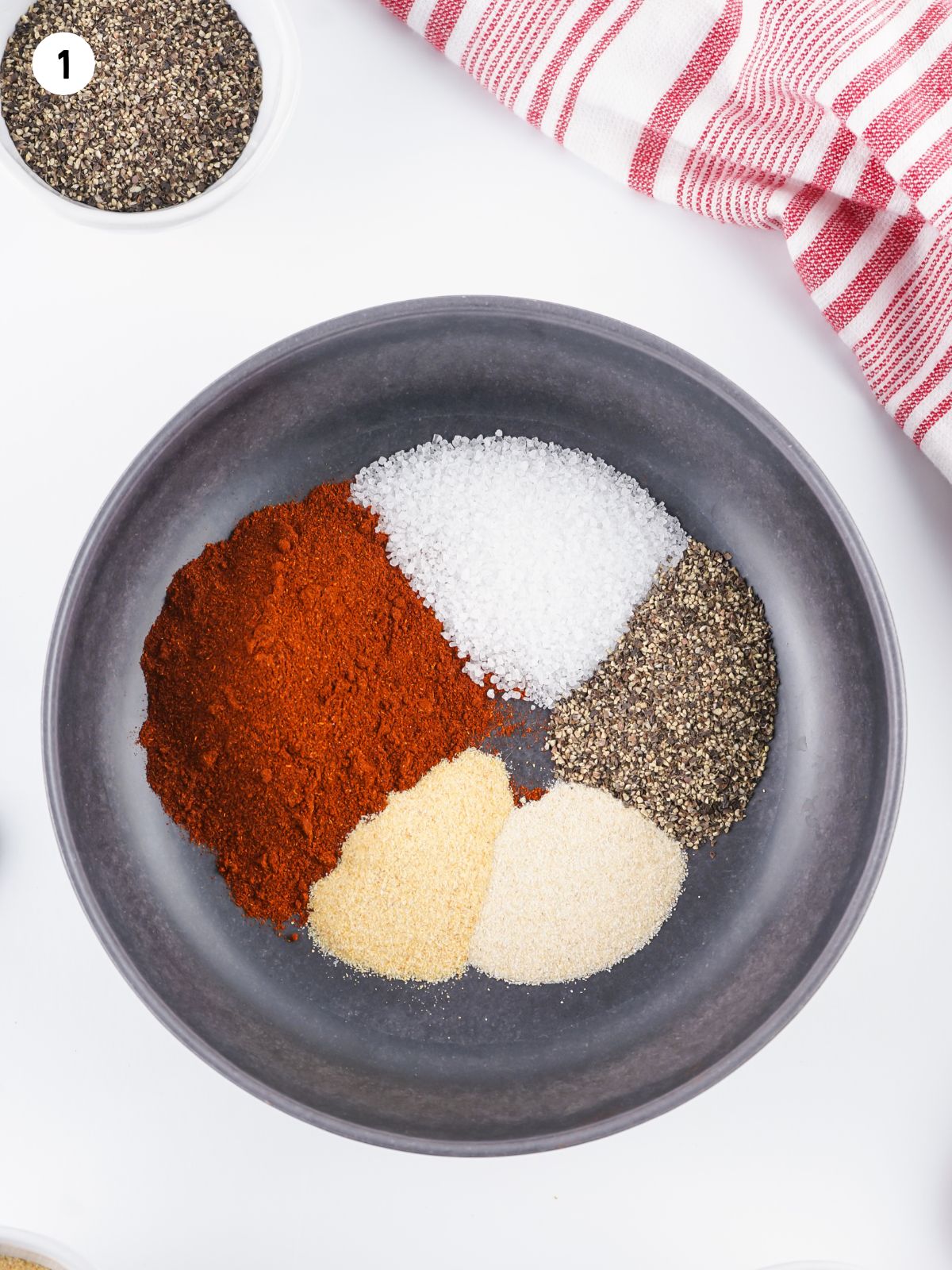 each ingredient measured out into a shallow black bowl
