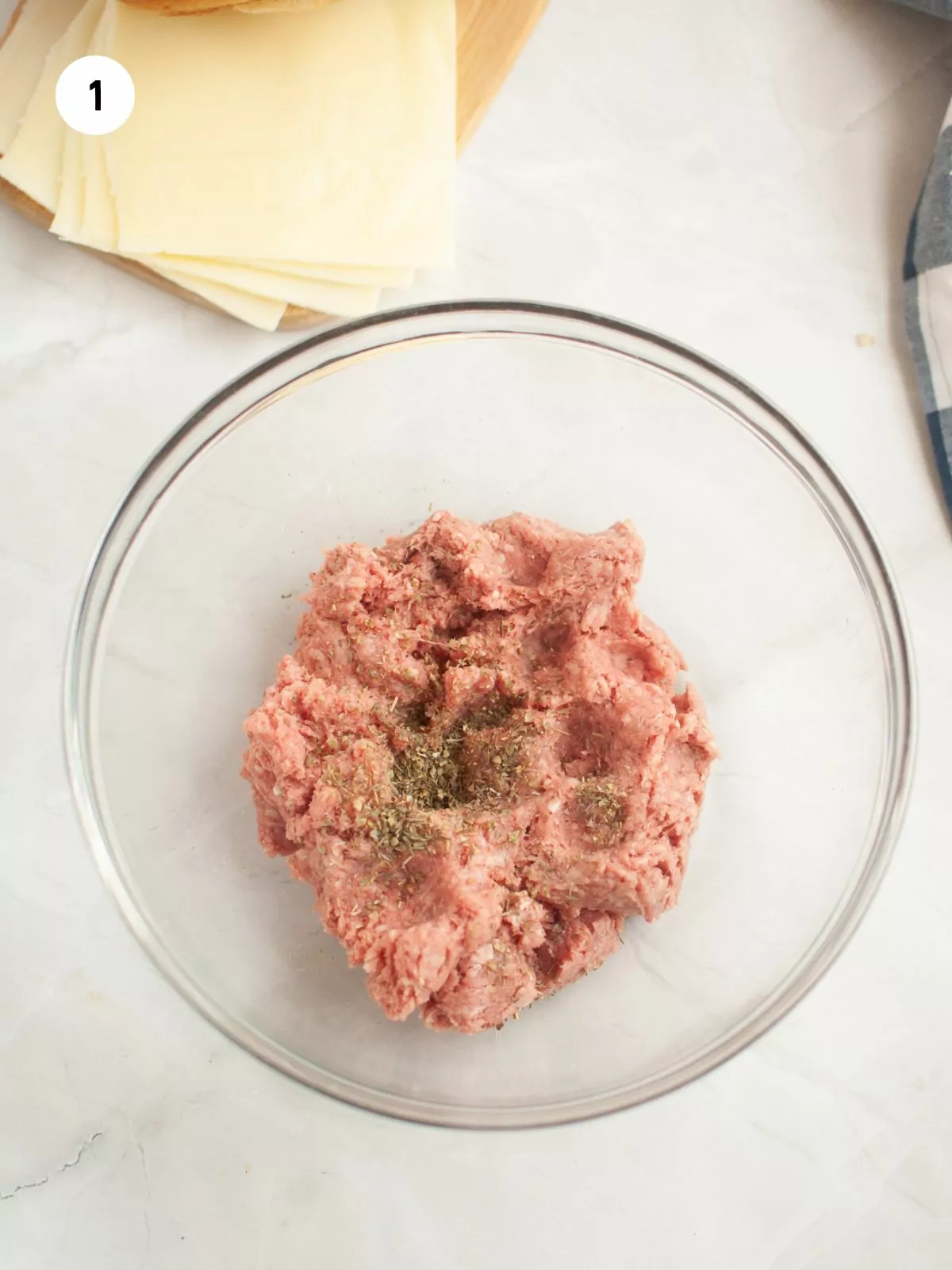 seasoned ground beef in a clear mixing bowl