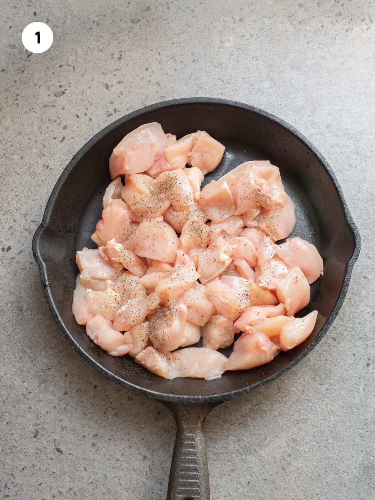 seasoned chicken in cast iron pan