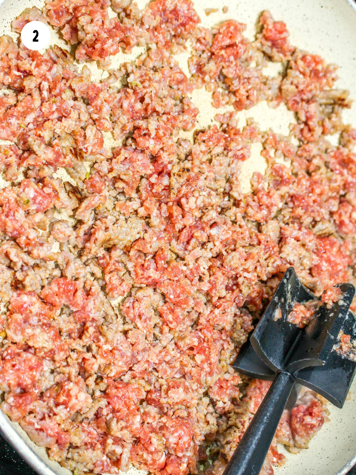 Italian sausage being browned in a pan