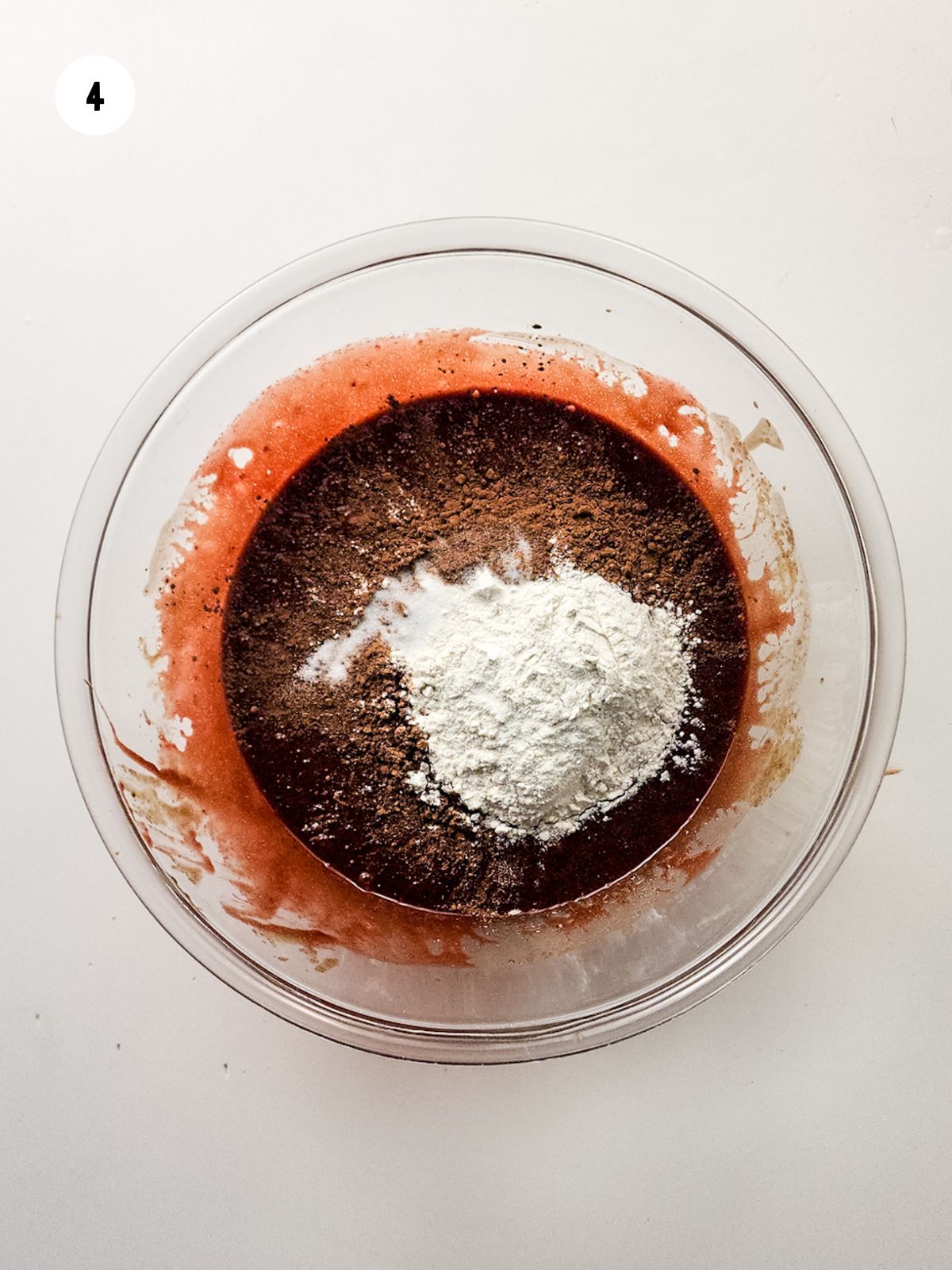 flour and cocoa powder added to the batter
