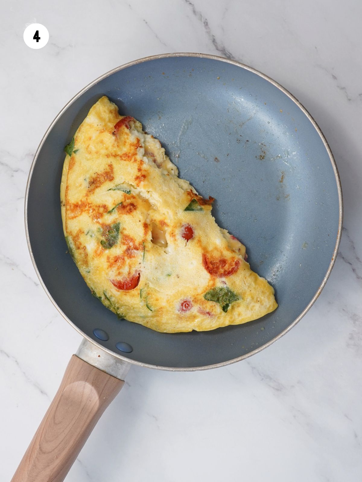 omelette folded in half in the pan