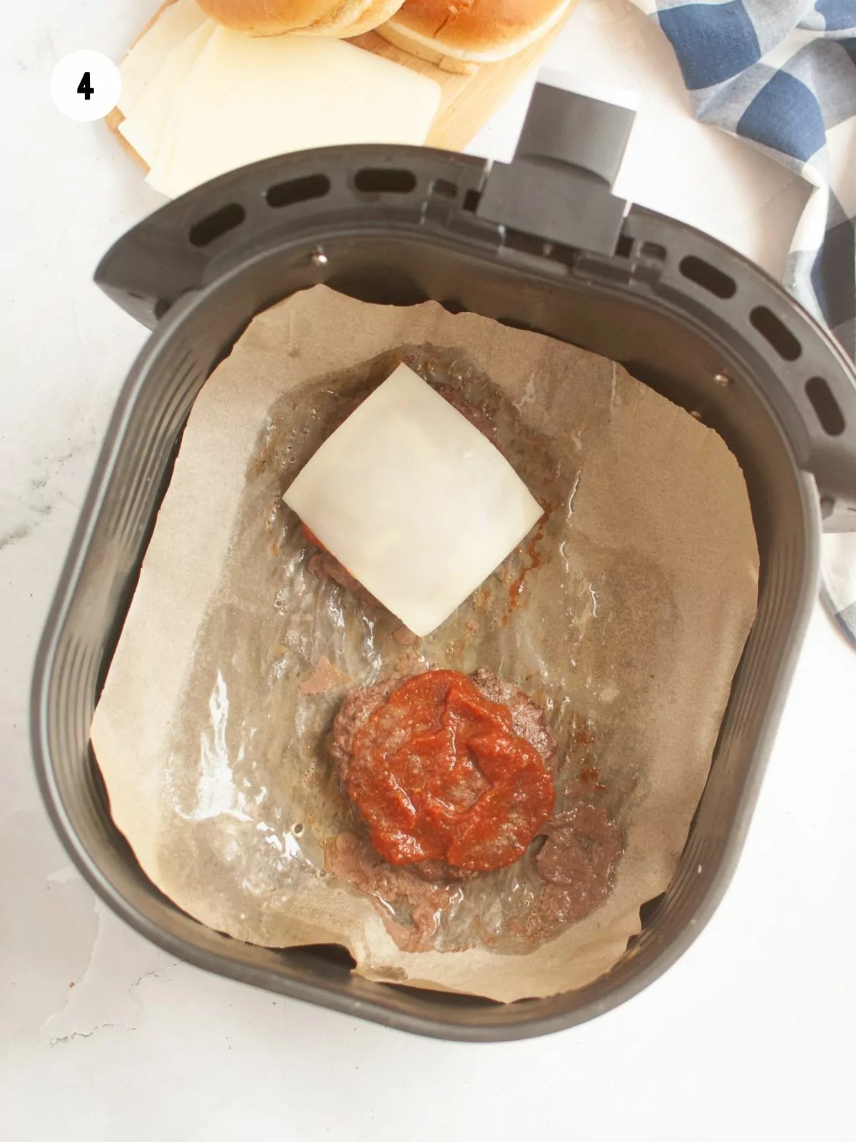 sauce and cheese added on top of the burger patties.
