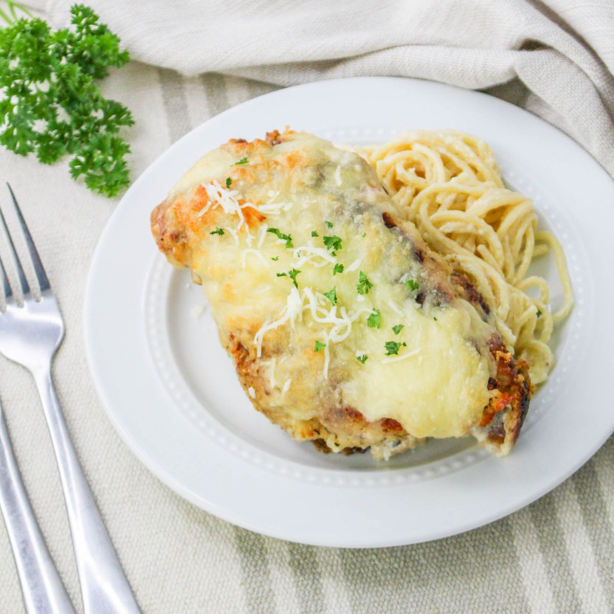 Baked Chicken Cutlet Alfredo served with pasta