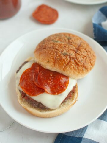 Pizza Burger with pepperoni served on a white plate