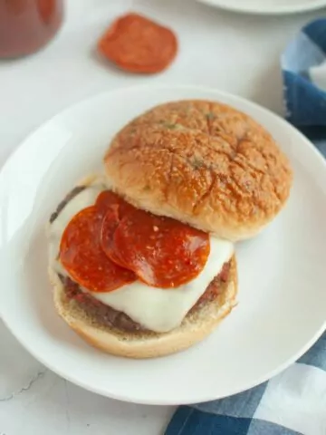 Pizza Burger with pepperoni served on a white plate