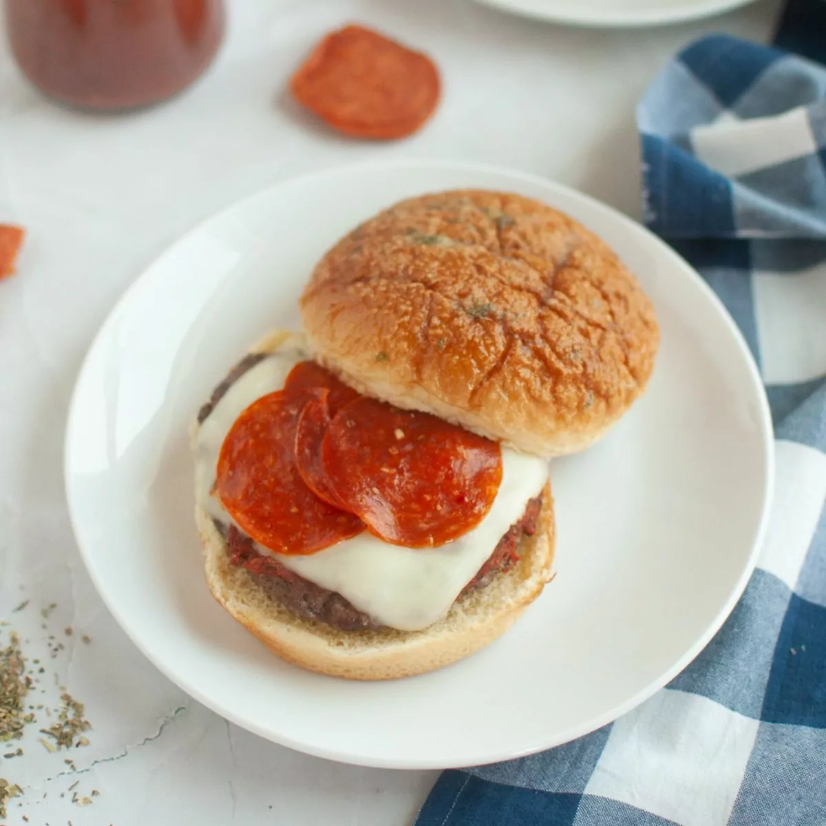 Pizza Burger with pepperoni served on a white plate