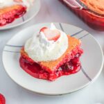 slice of Strawberry Dump Cake served with whipped topping