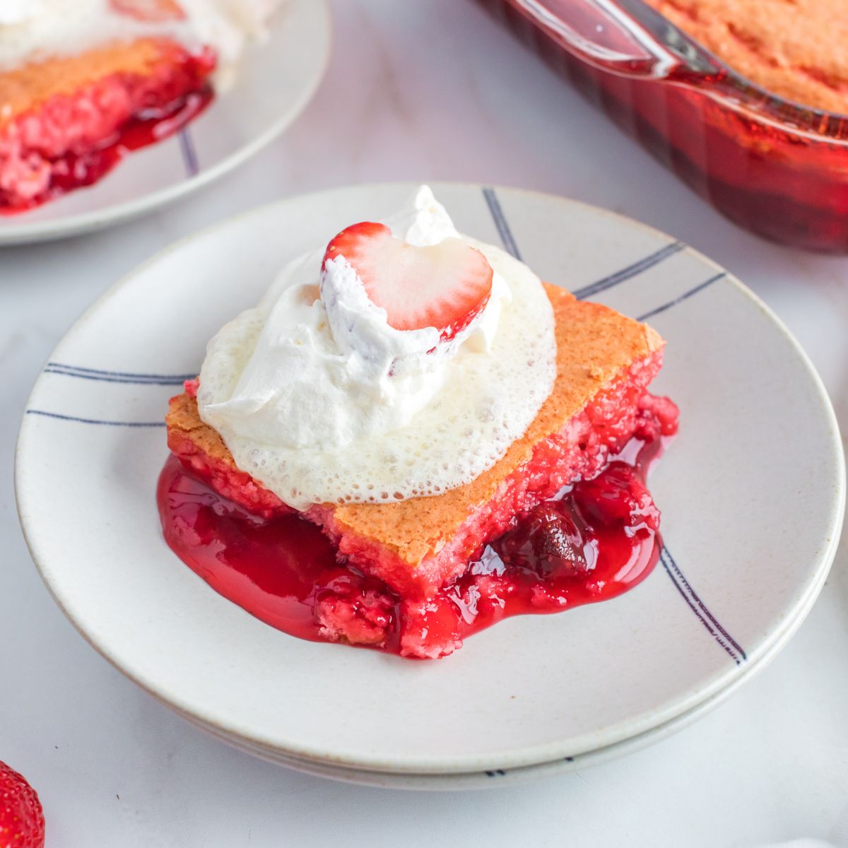 slice of Strawberry Dump Cake served with whipped topping