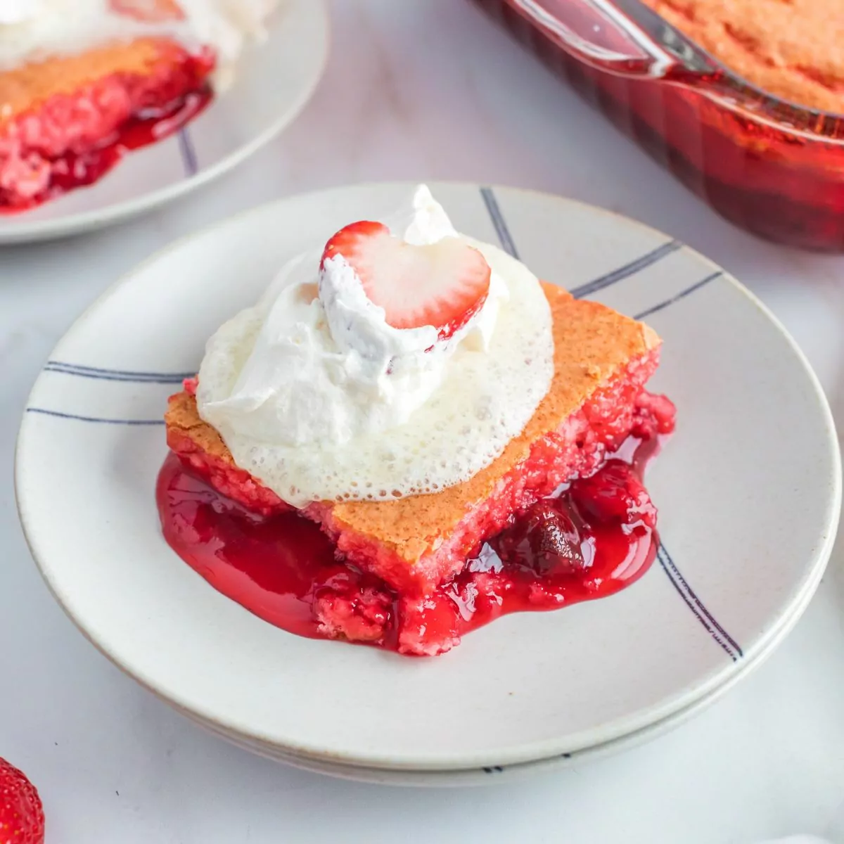 slice of Strawberry Dump Cake served with whipped topping