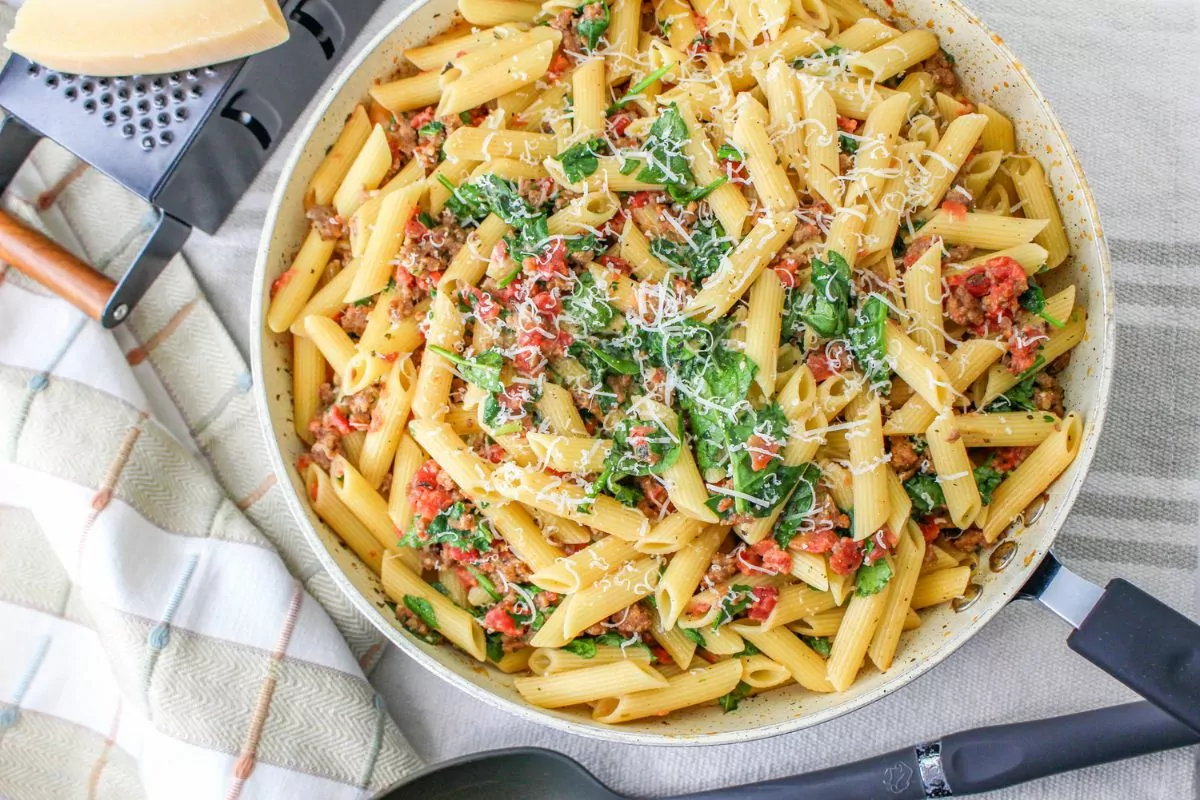Creamy Sausage Pasta with Spinach in a large pan