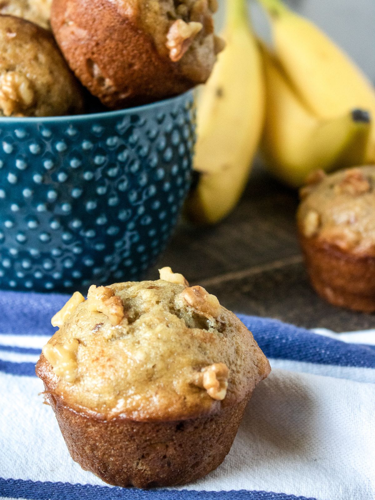 banana muffin with fresh bananas in the background