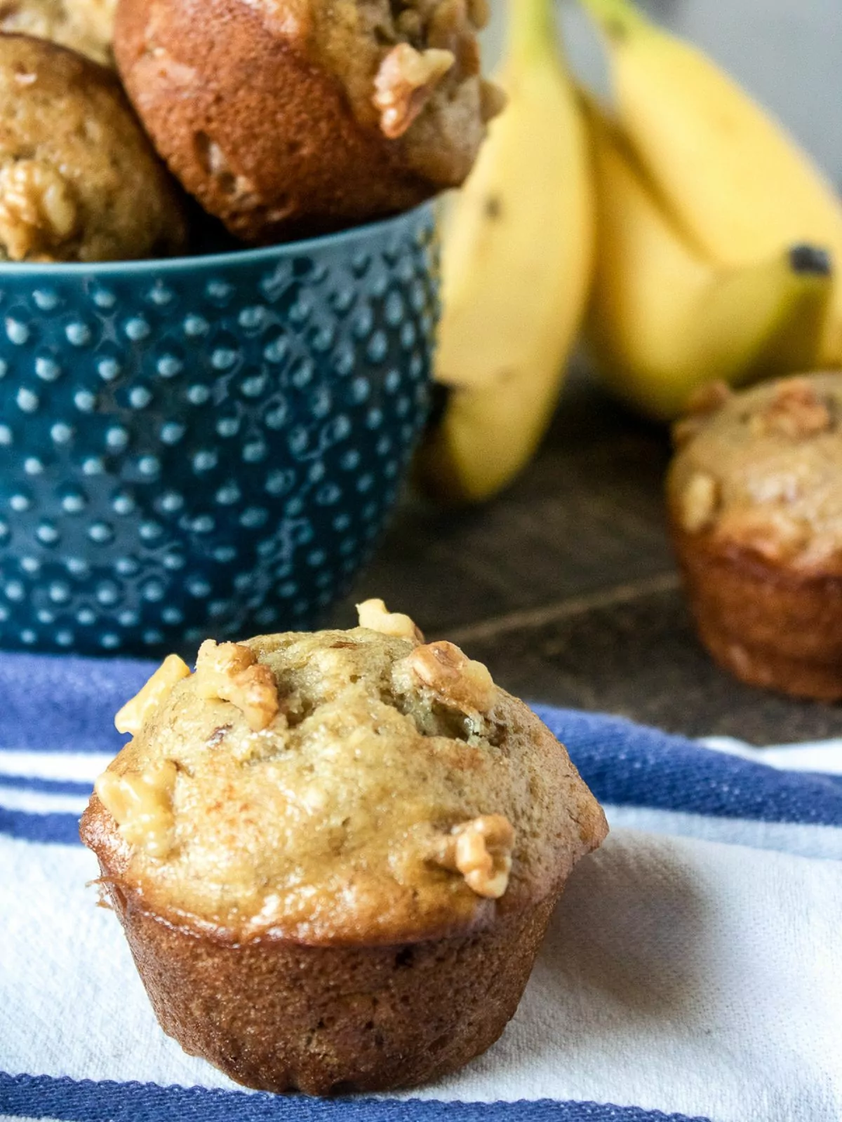 banana muffin with fresh bananas in the background