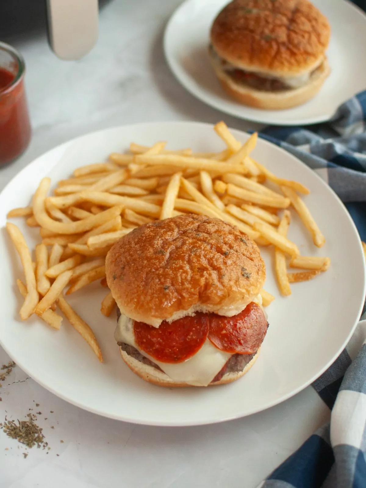 Pizza burger served with fries