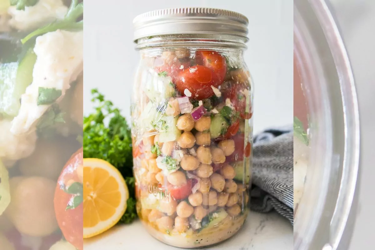 chickpea salad in a mason jar with cucumbers and tomato.
