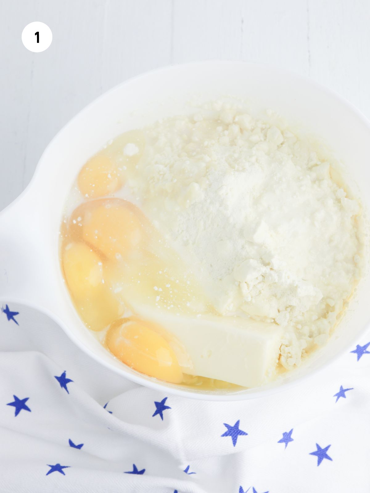 Ingredients for the cake in a white mixing bowl.
