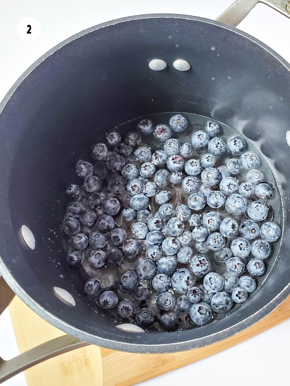 fresh blueberries added to the sugar water