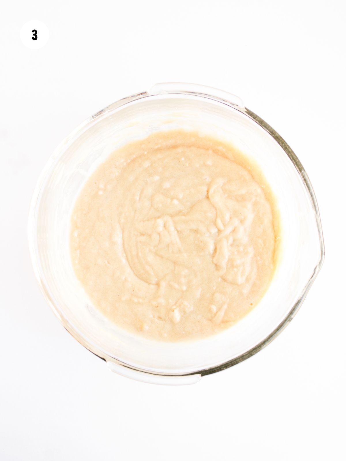 dry and wet ingredients combined in a clear mixing bowl