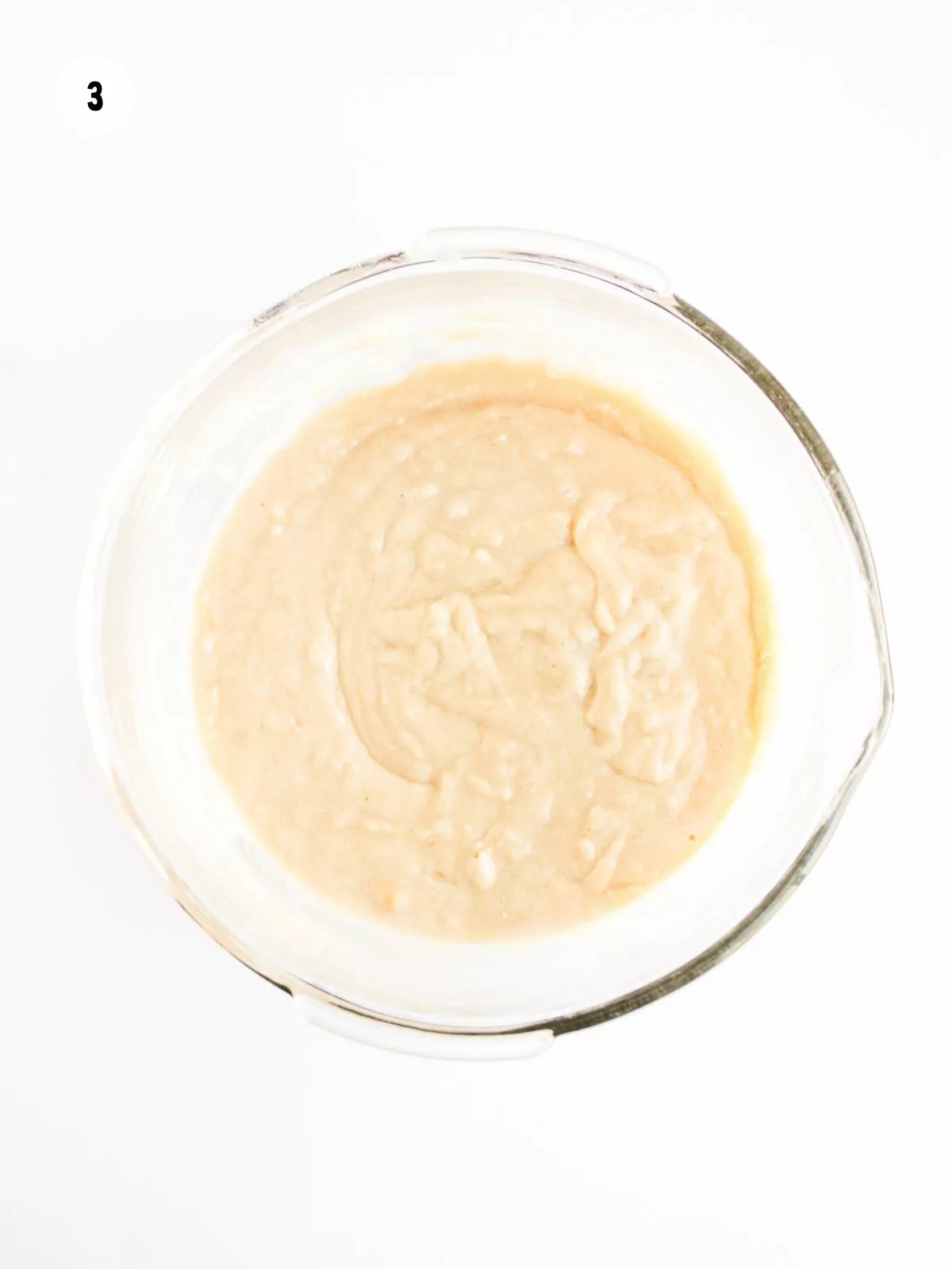 dry and wet ingredients combined in a clear mixing bowl