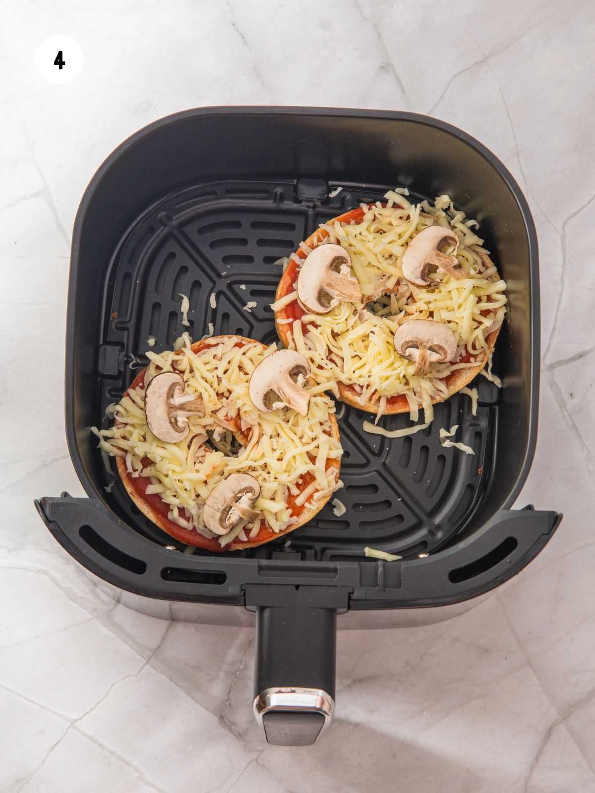 Sliced mushrooms placed on top of the mozzarella.