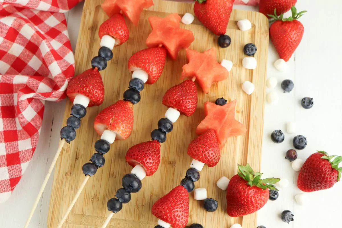 Kabobs made with blueberries, mini marshmallows, strawberries, and star shaped watermelon.