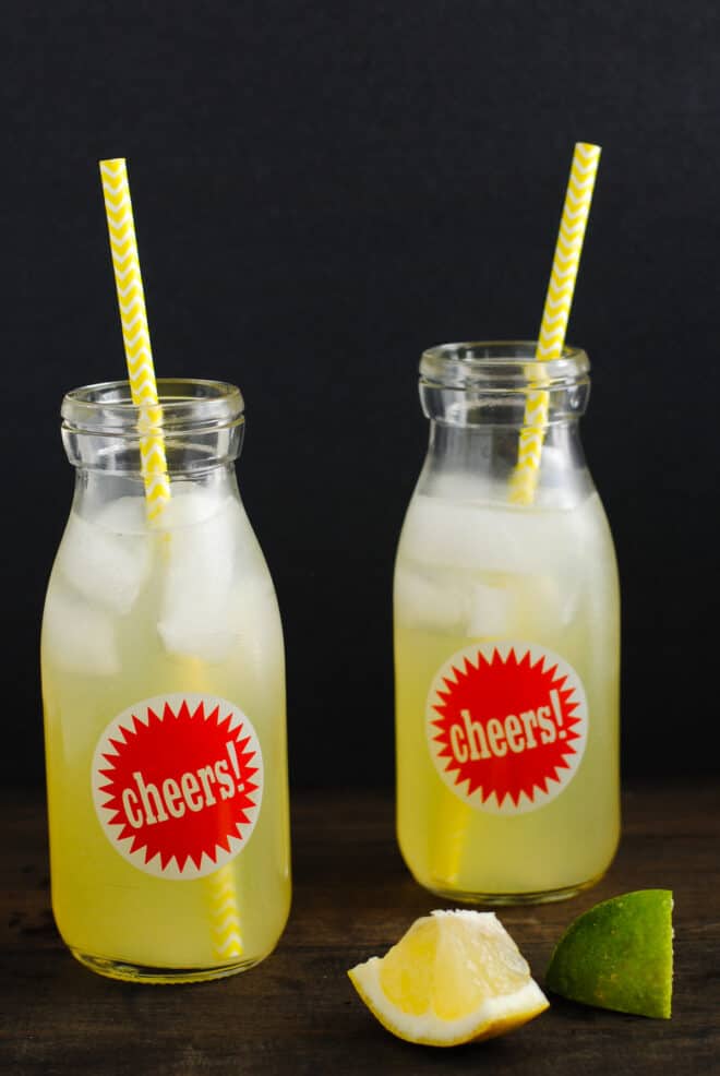 two bottles of lemon juice with yellow straw
