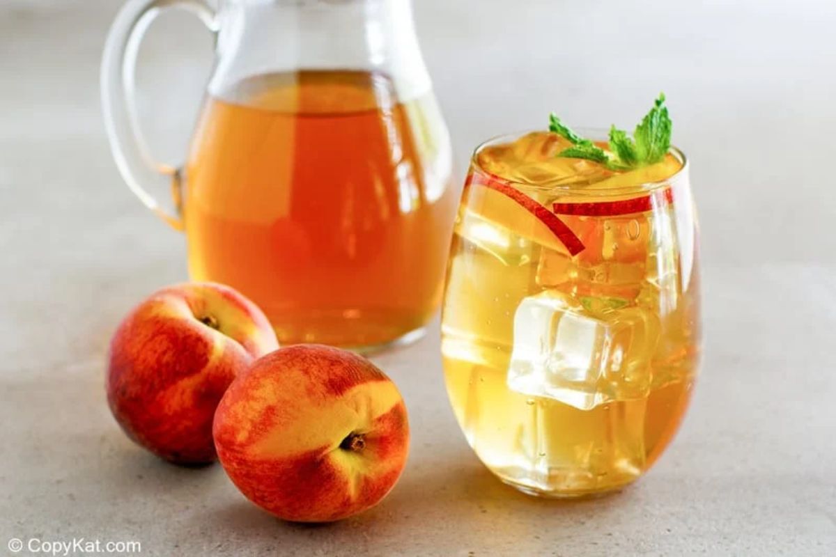 pitcher and glass olive garden peace iced tea with peach at the side