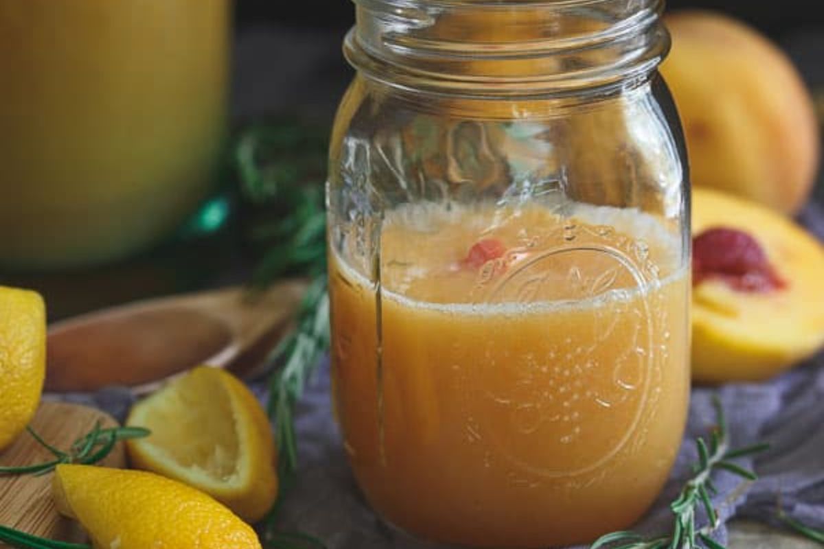 glass of roasted peach rosemary lemonade