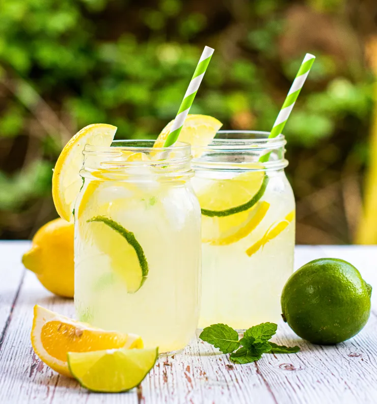 two glass of lemonade with lemon and lime and straw