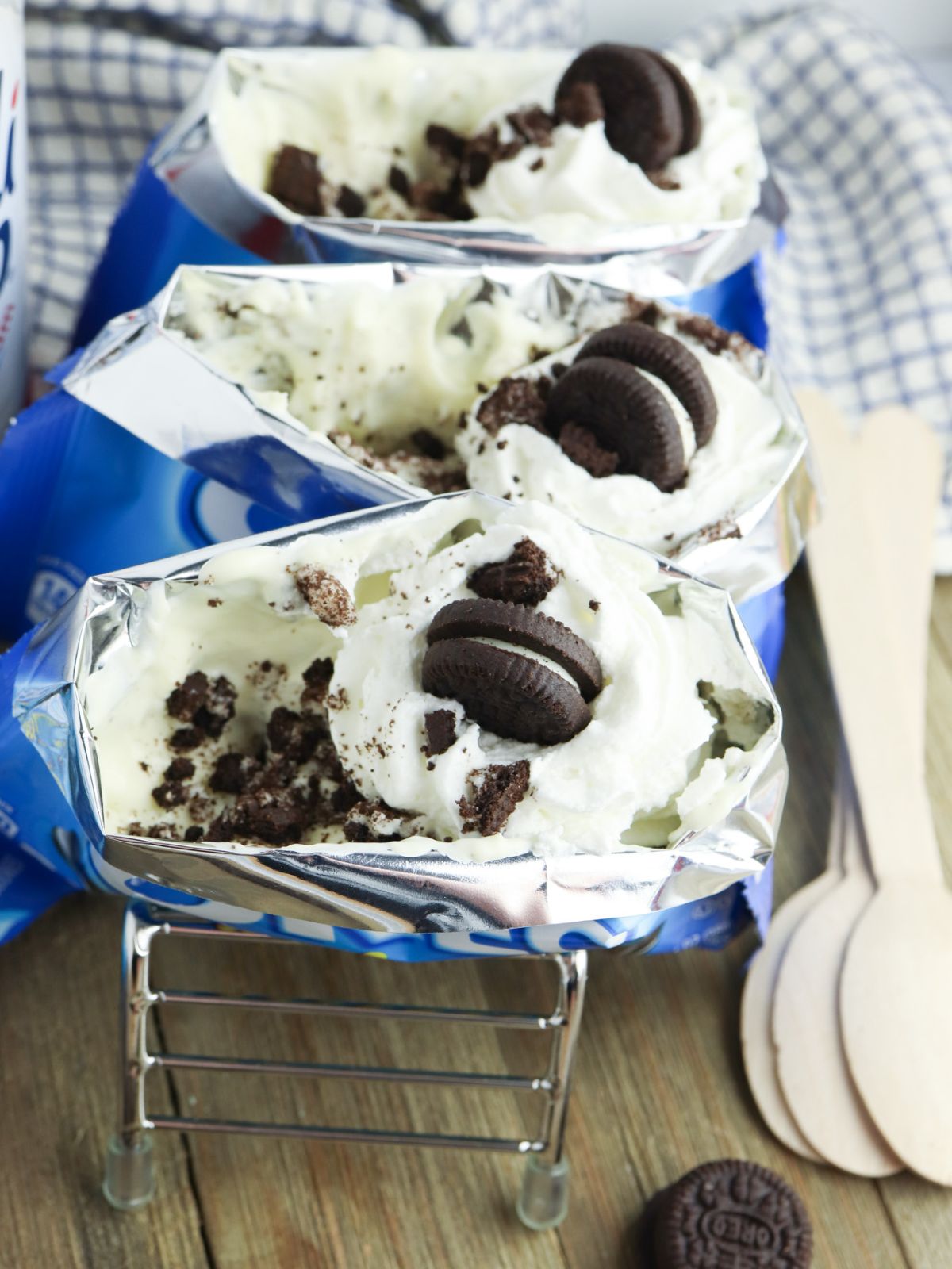 bags of mini oreos filled with cheesecake filling, whipped cream, and mini oreos