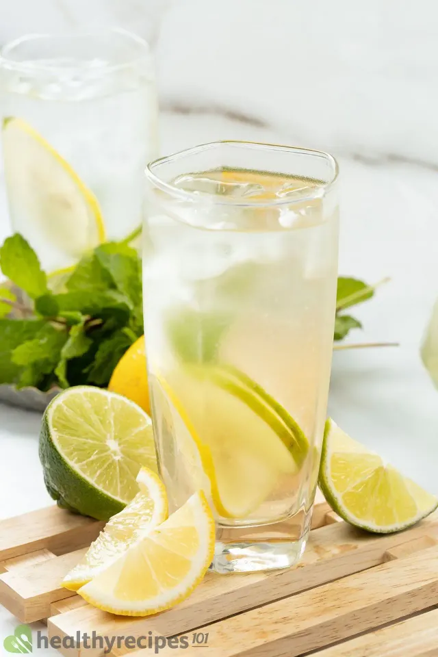 Glass of sparkling water with lemon and lime and ice