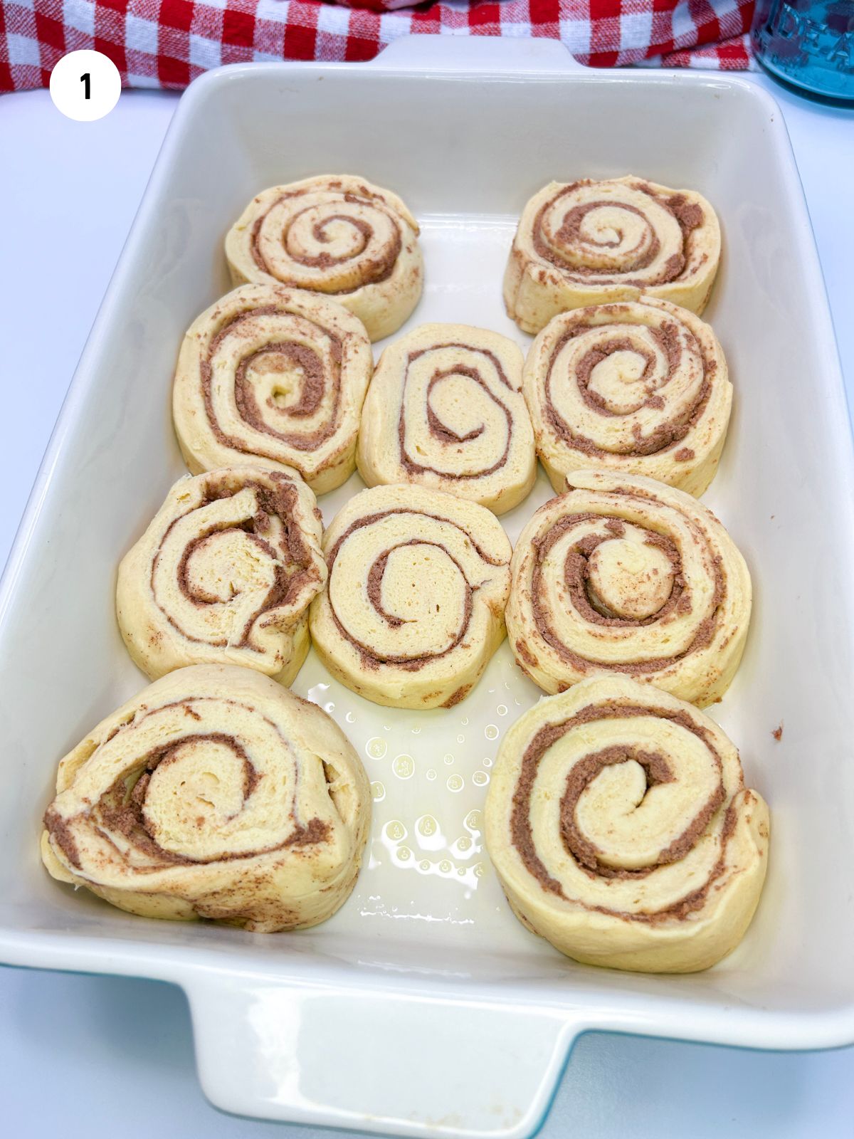 Cinnamon rolls placed in a 9x13 baking dish.