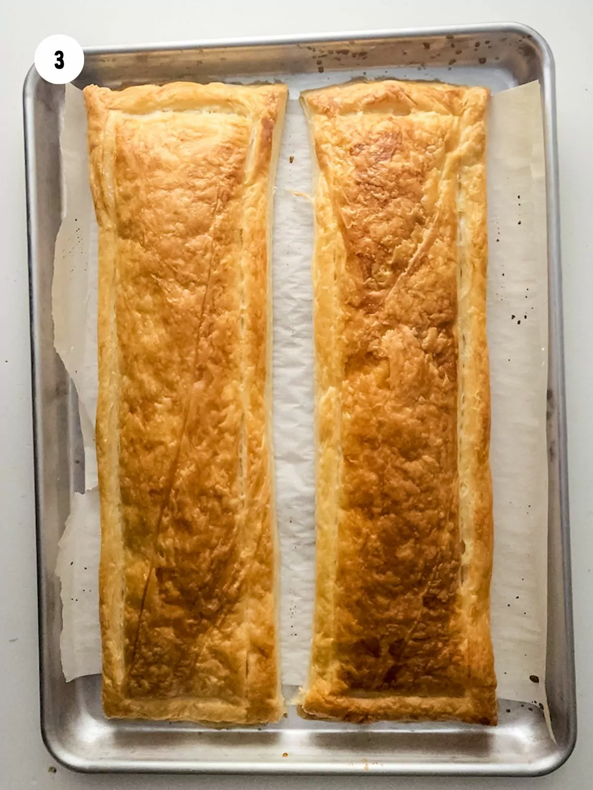 Baked puff pastry on baking sheet.